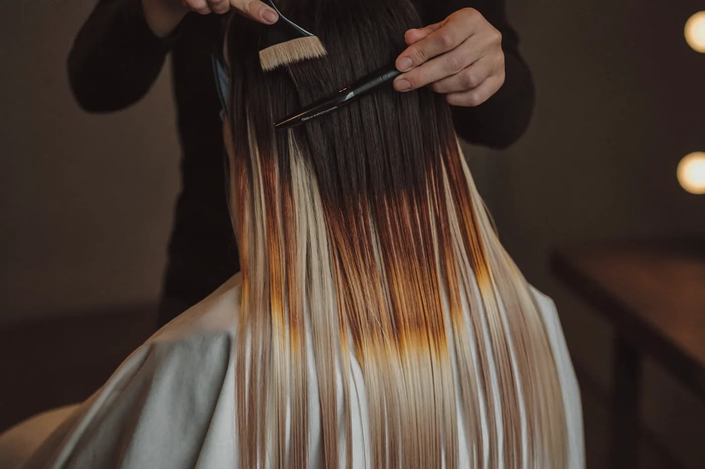 Stylist finishing a precision blow-dry at NJS